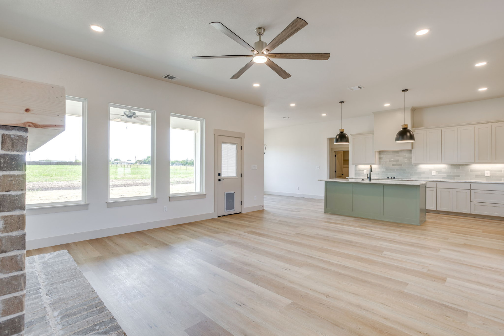 View from the fireplace toward the kitchen and dining areas