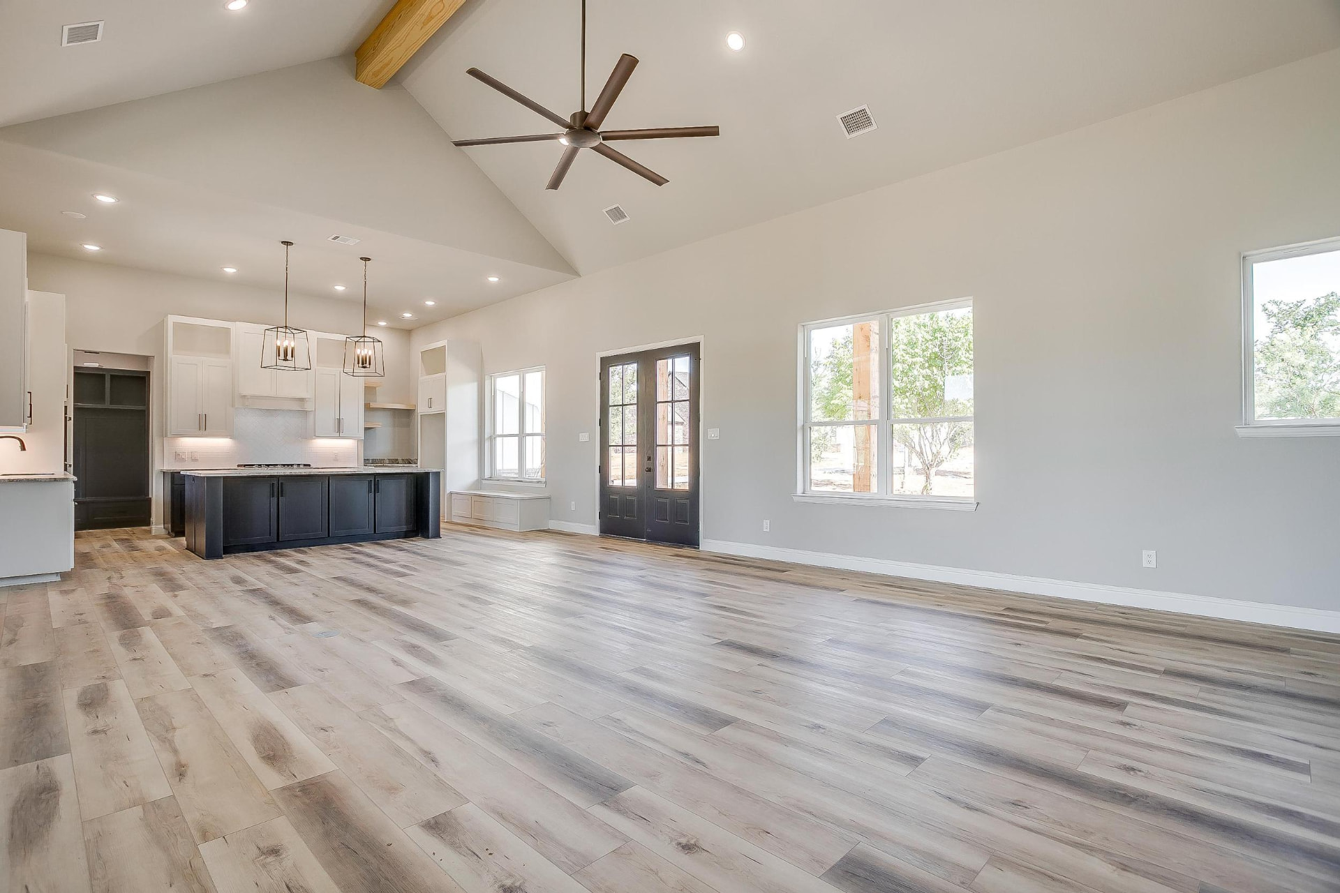 Open-concept living space looking toward the navy kitchen island