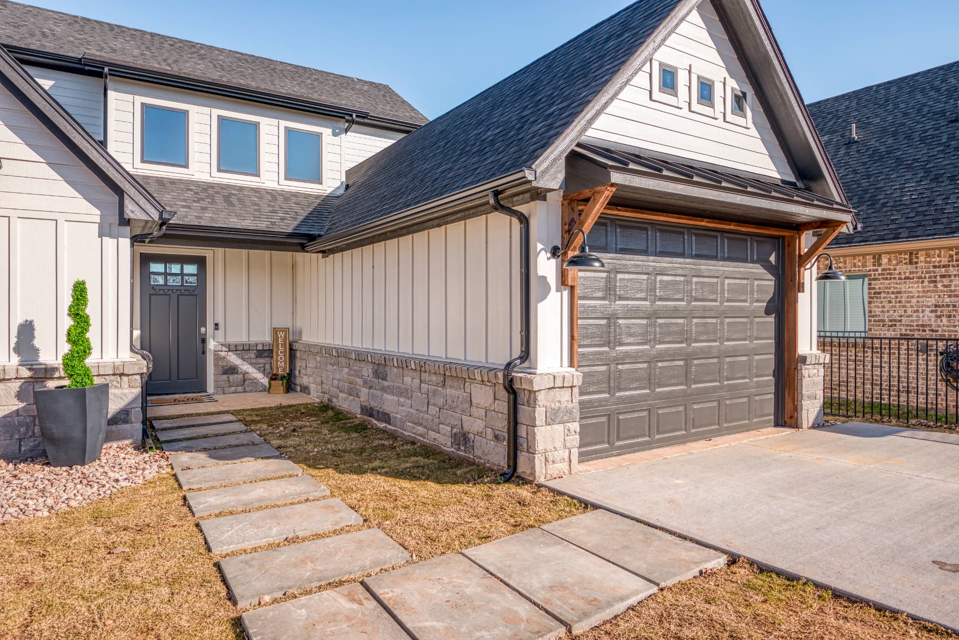 Entry and garage elevation with black gooseneck lighting