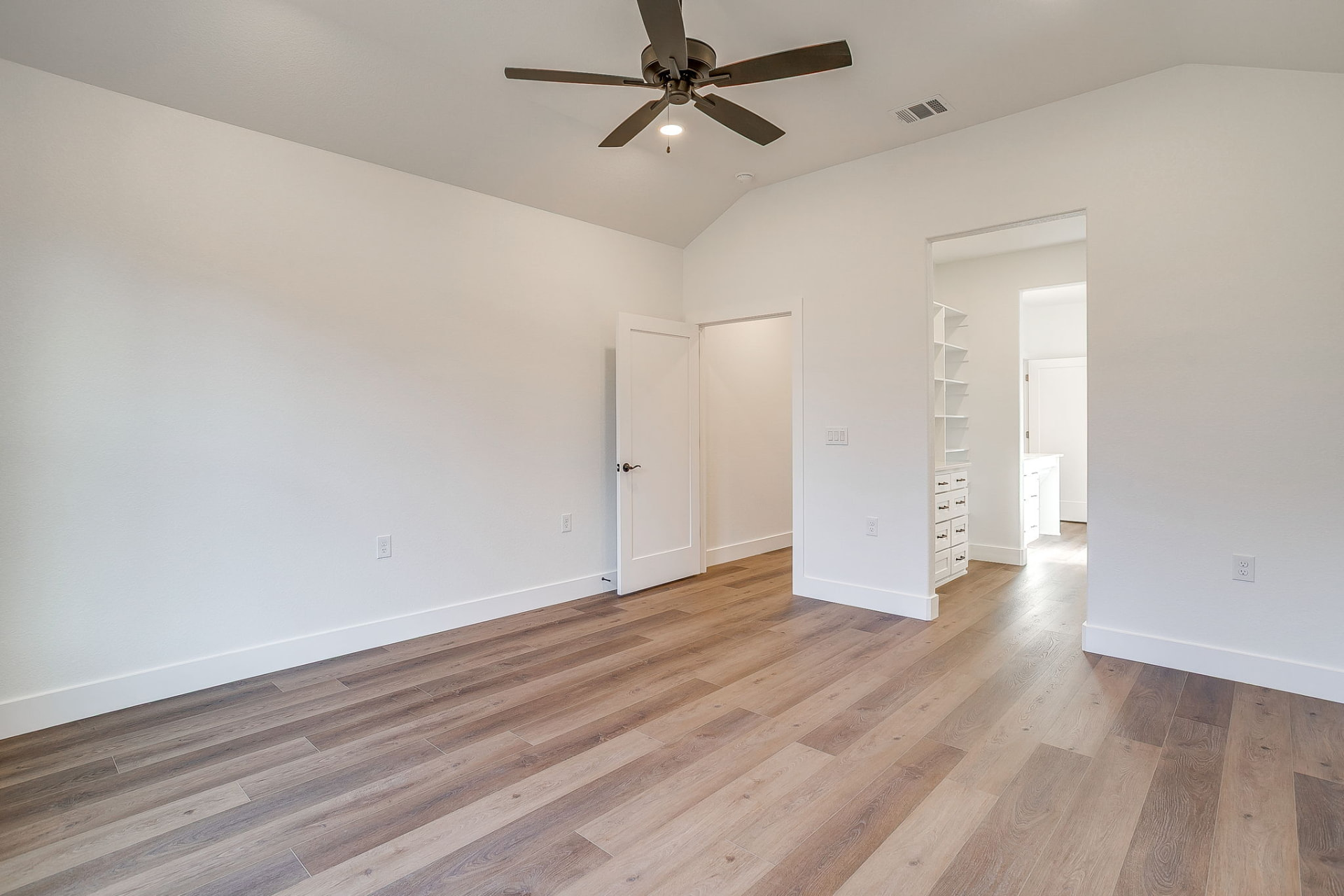 Walk-in closet with custom white built-in shelving