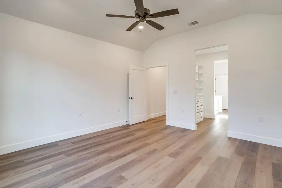 Walk-in closet with custom white built-in shelving