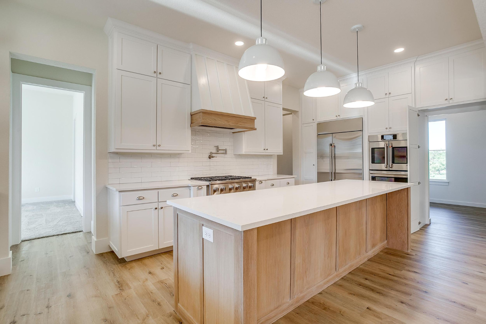 Kitchen with built-in stainless refrigerator and double ovens