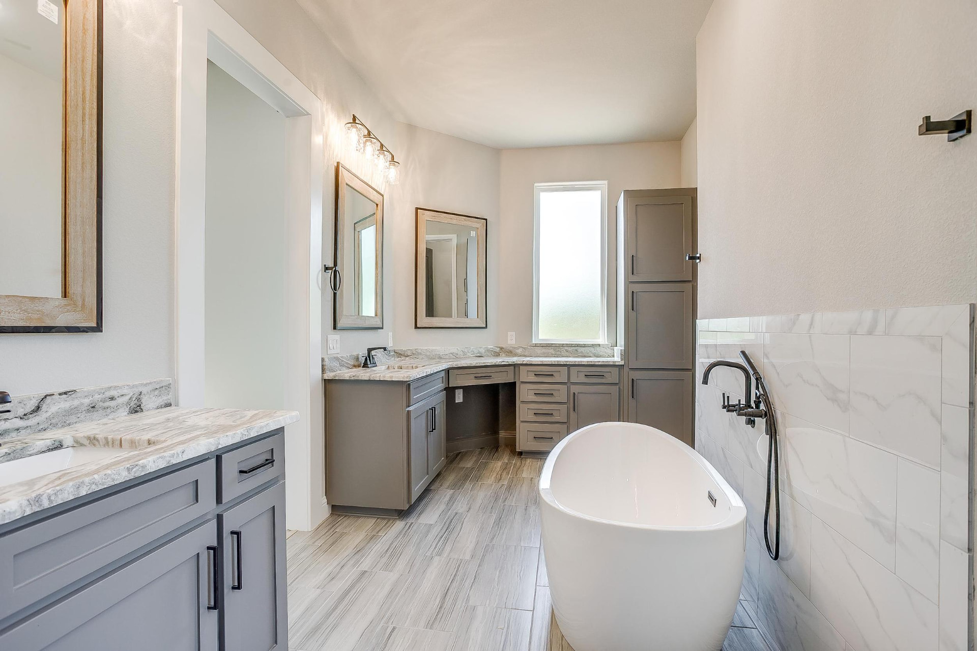 Primary bath vanities, makeup counter, and linen tower