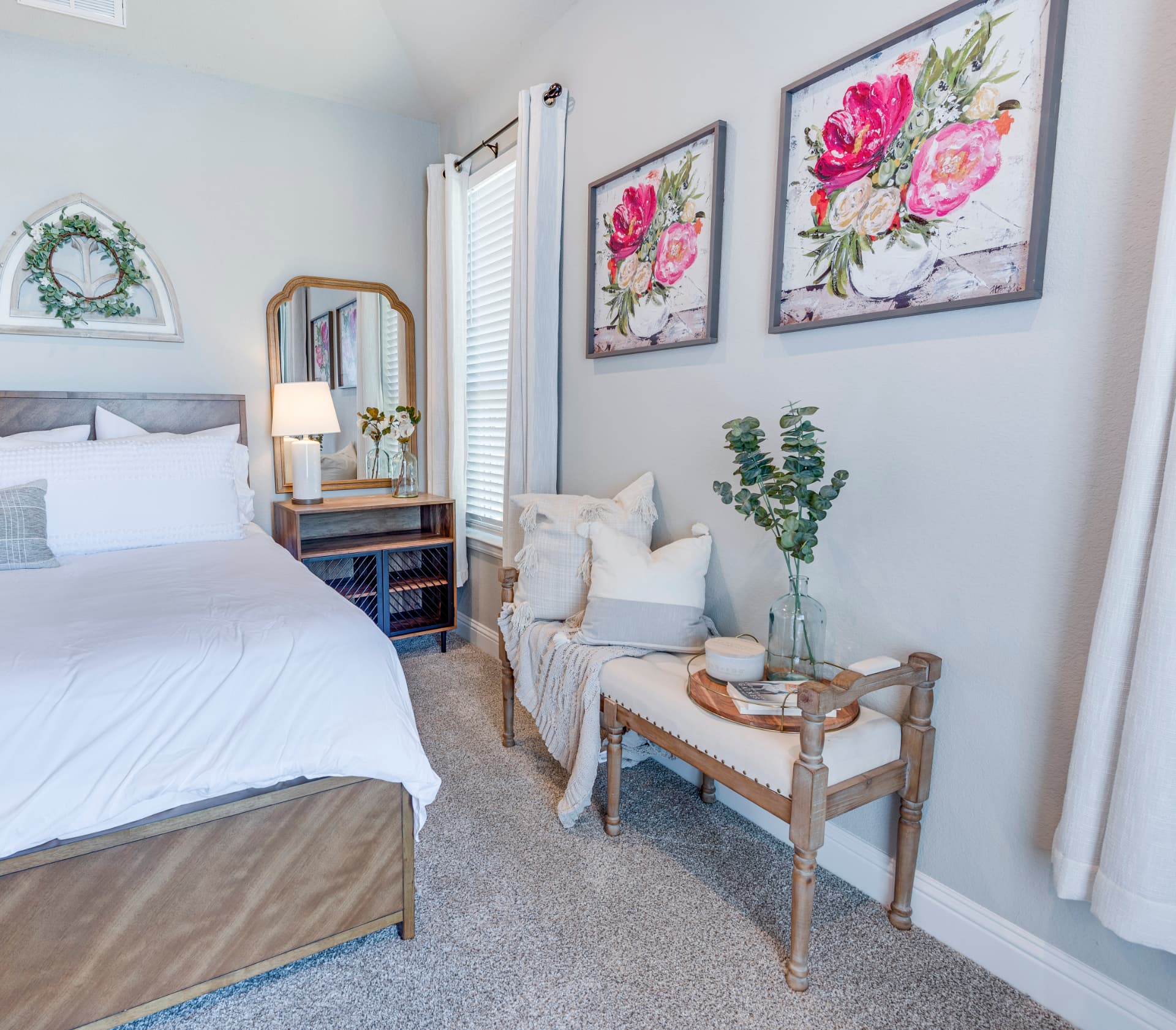 Bedroom with layered bedding and corner decor