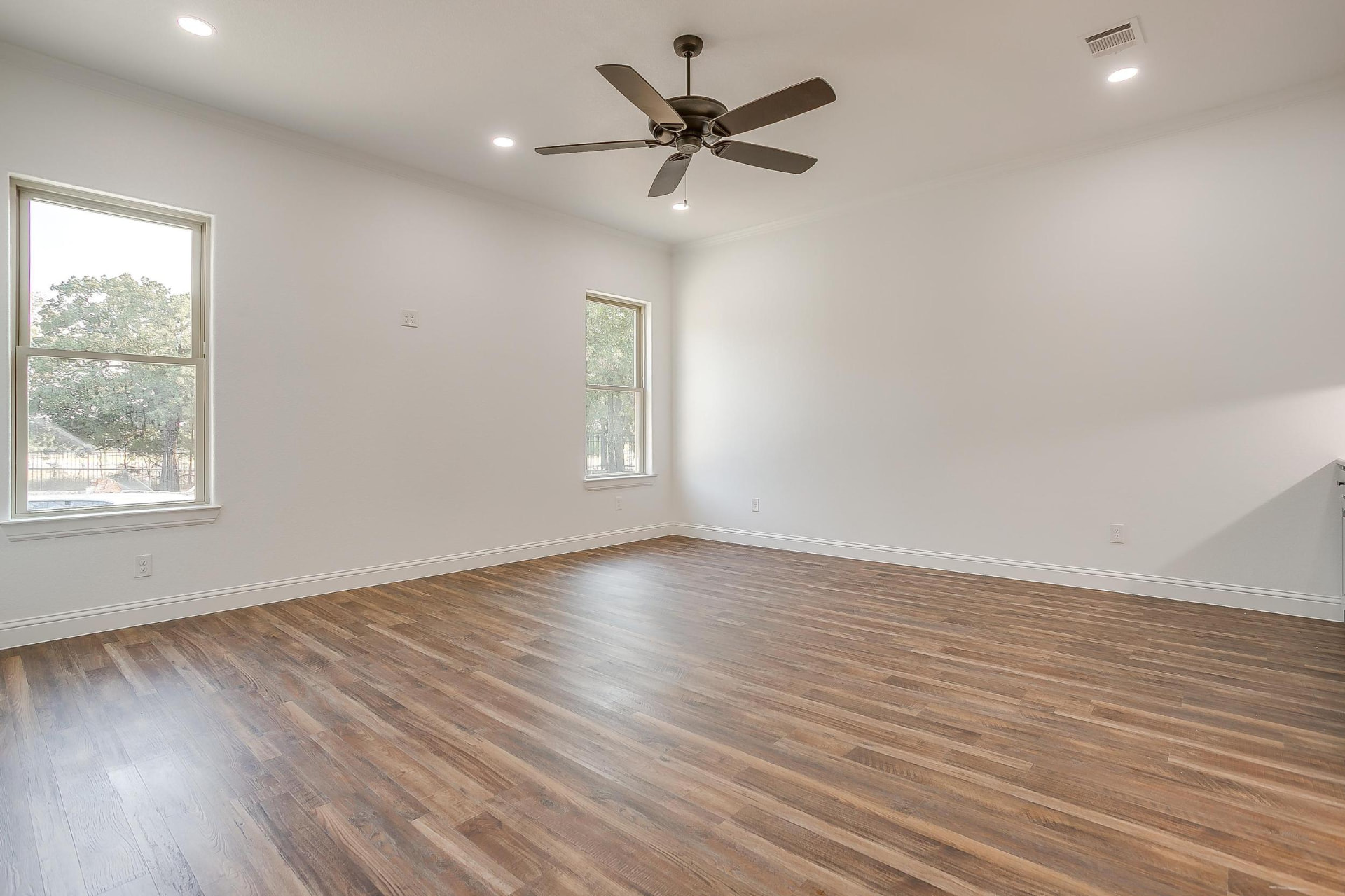 Game room with dark wood flooring and ceiling fan