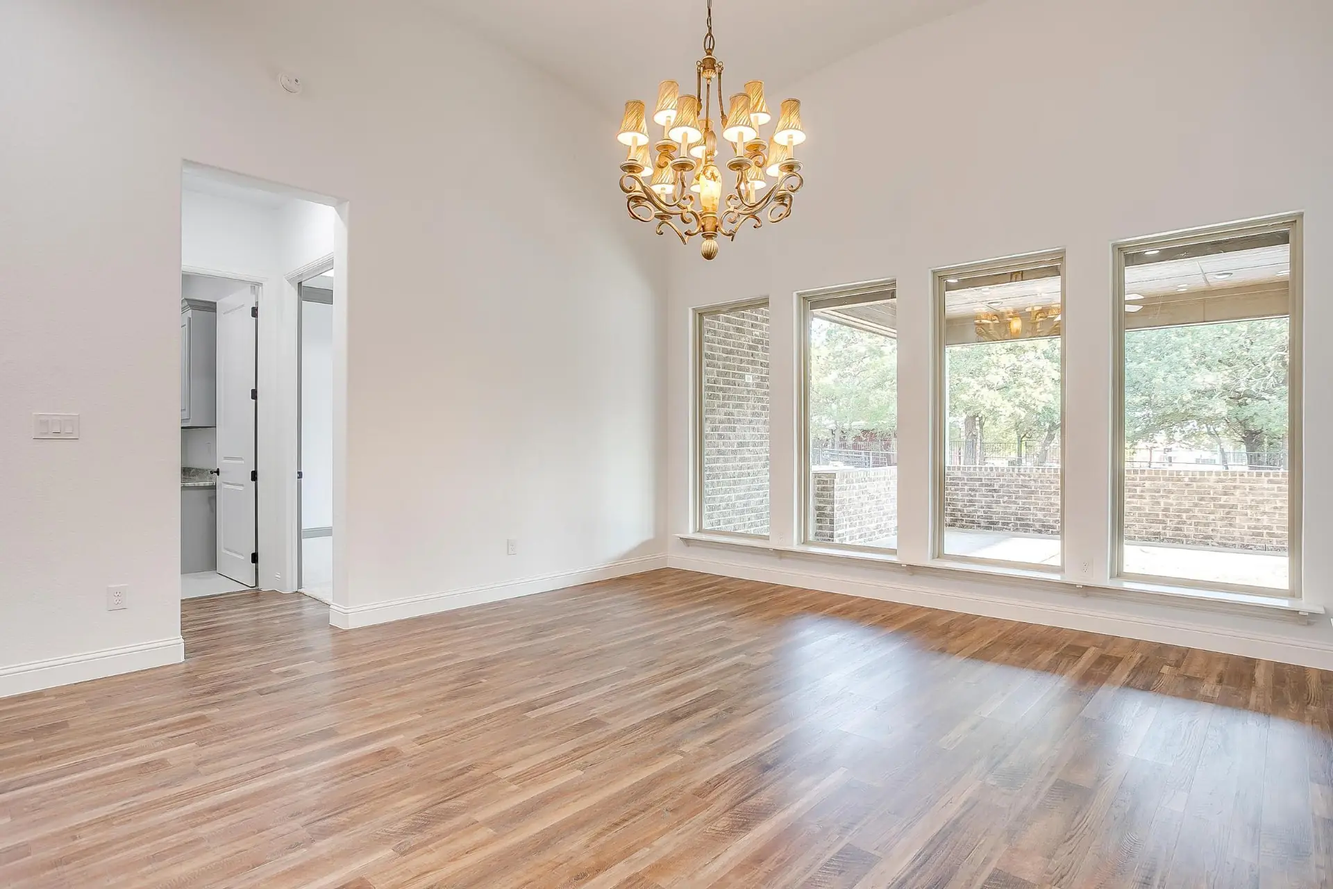 Formal dining room with a vaulted ceiling and chandelier