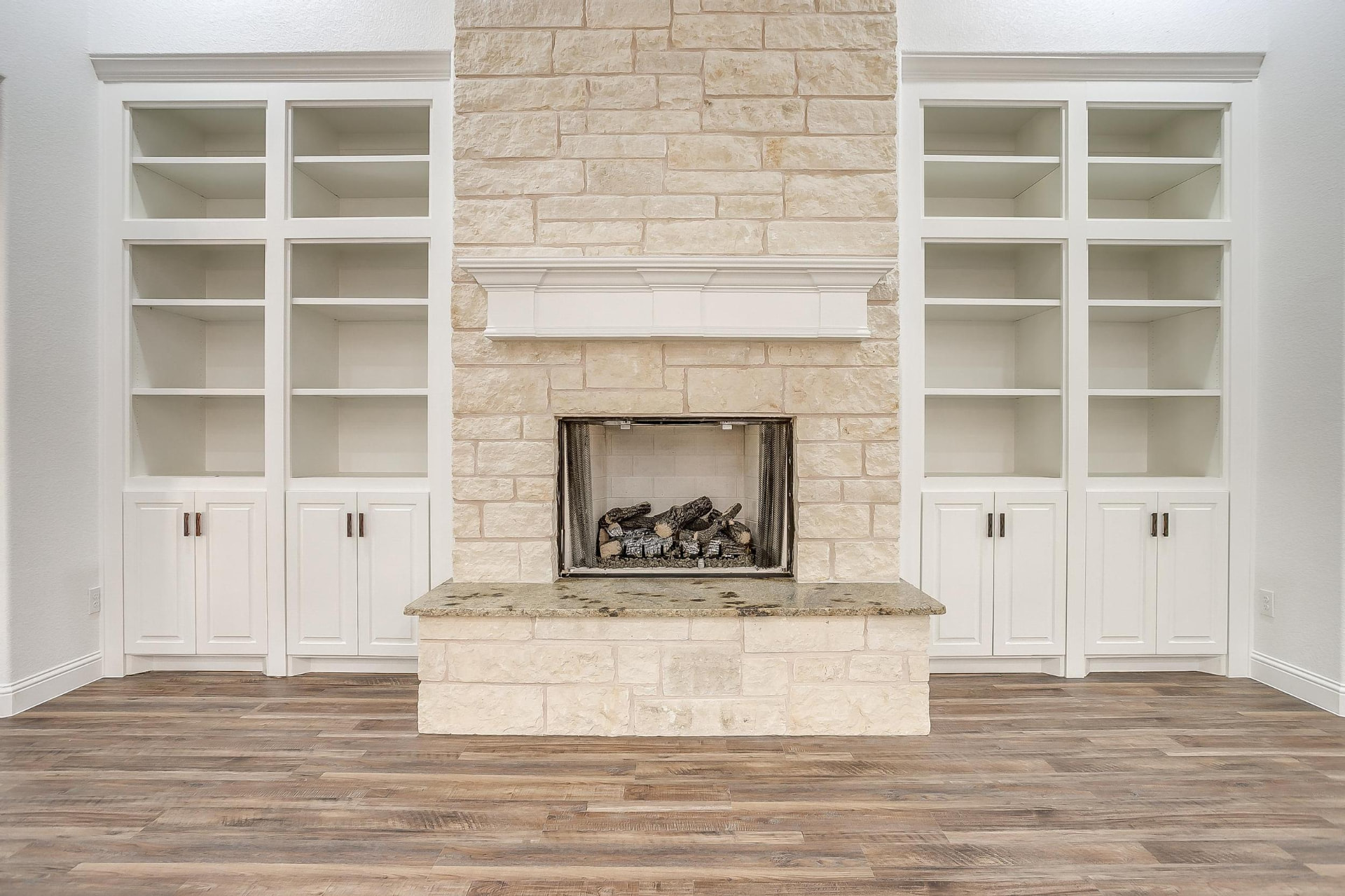 Wide view of the great room and stone fireplace wall