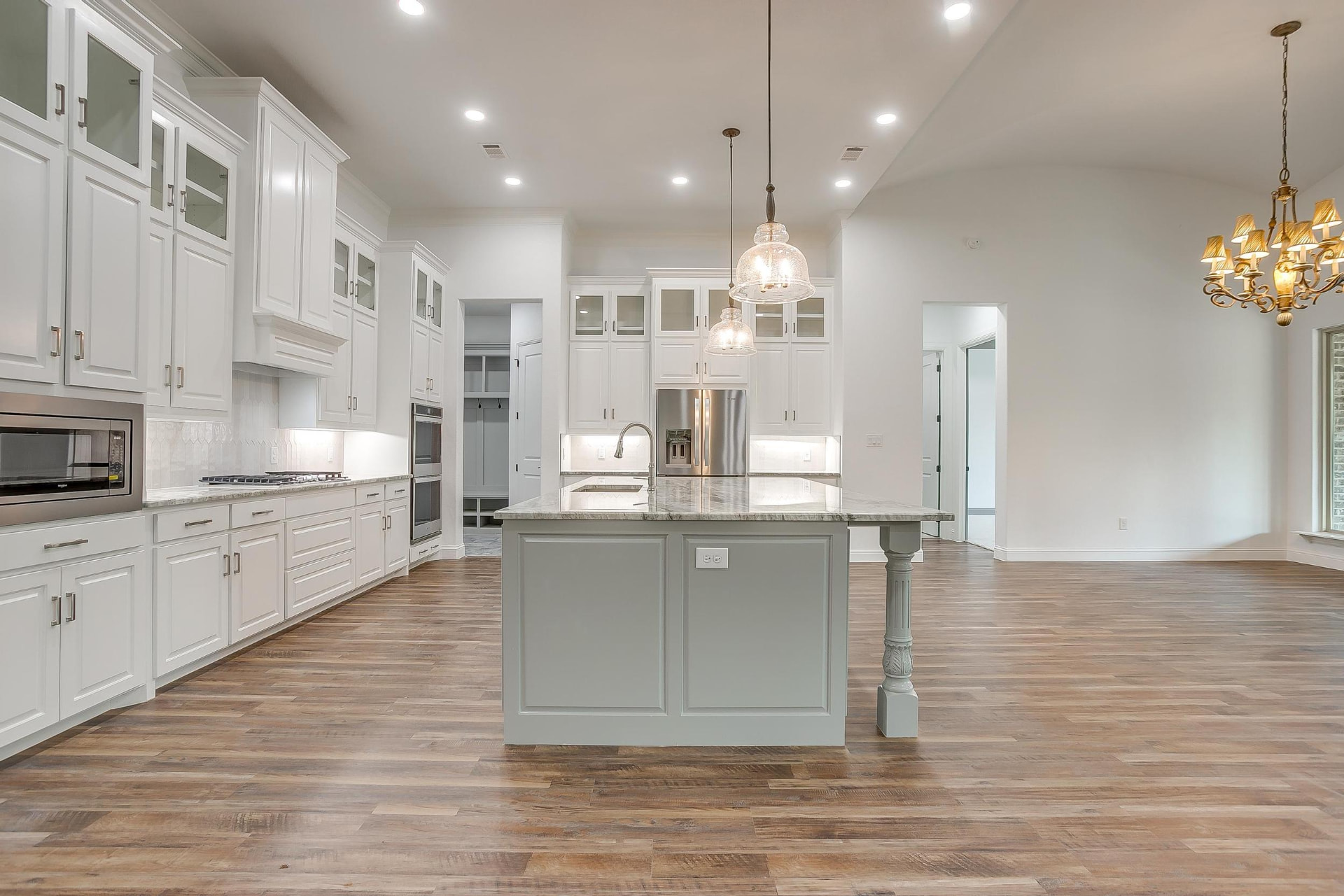 Open kitchen and dining area with vaulted ceiling