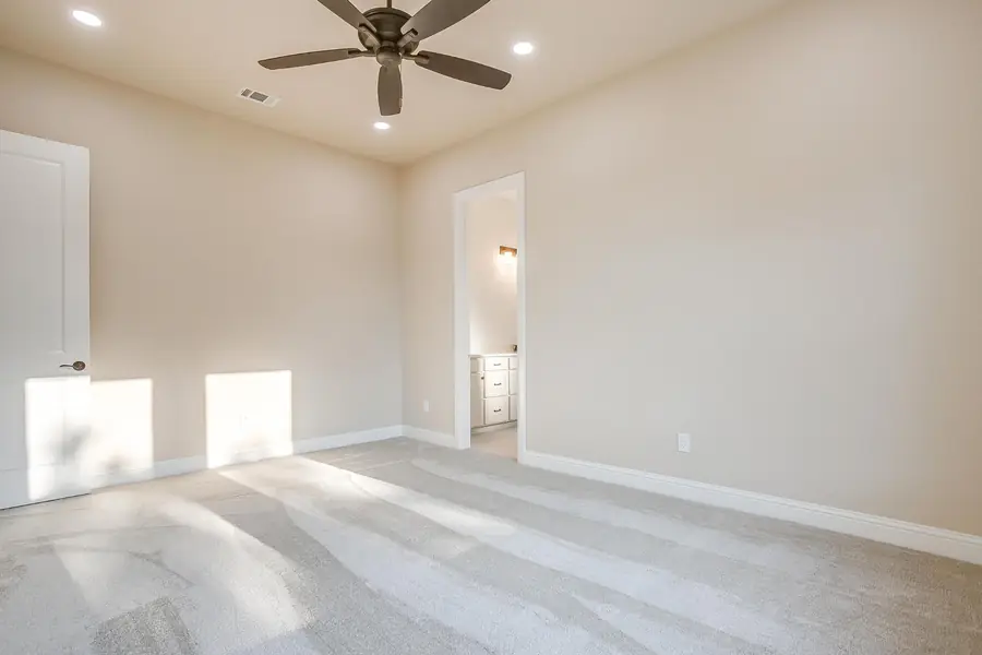 Bright bedroom with sunlight across the carpet