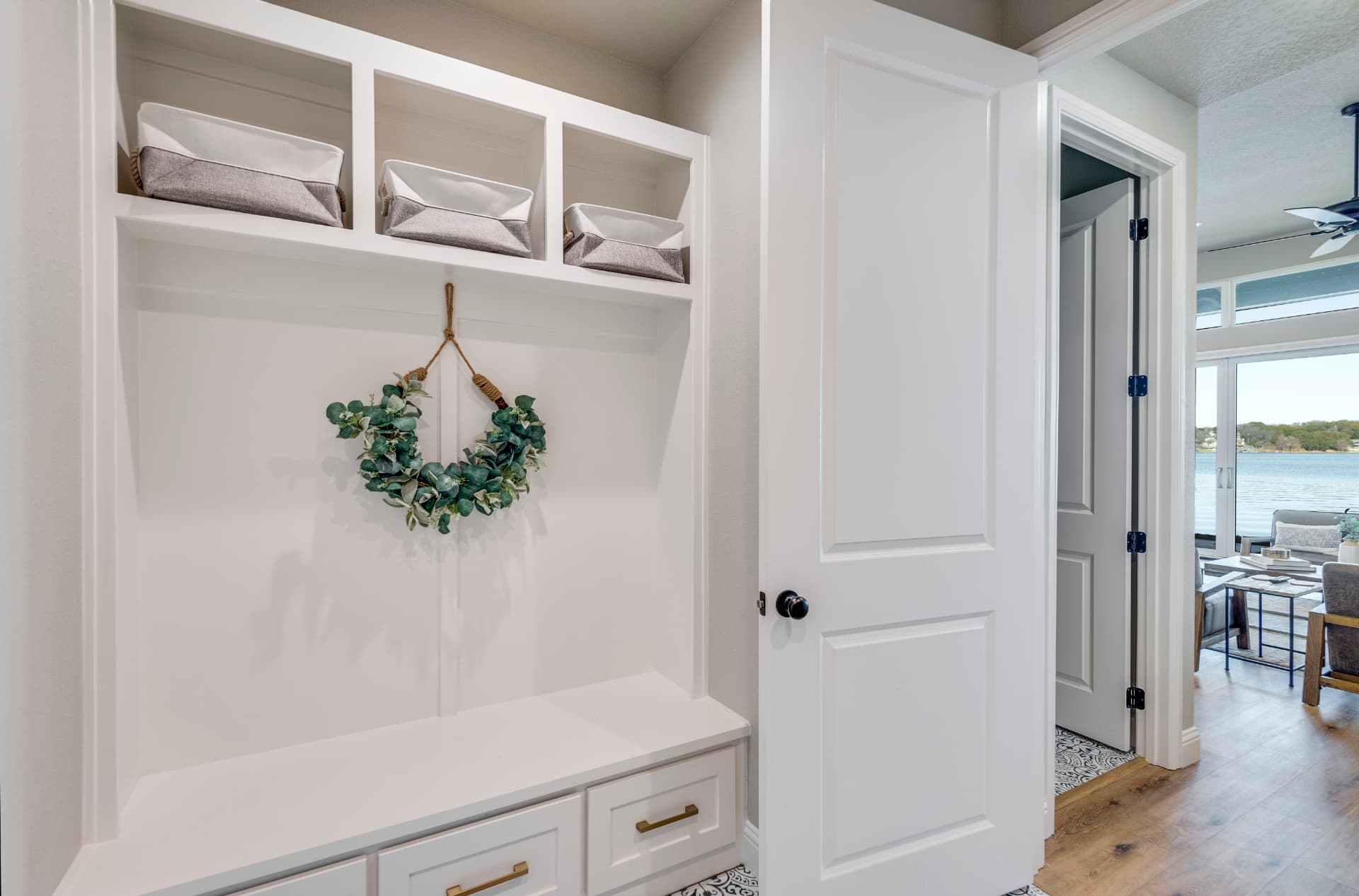 Mudroom with white built-in cubbies and bench