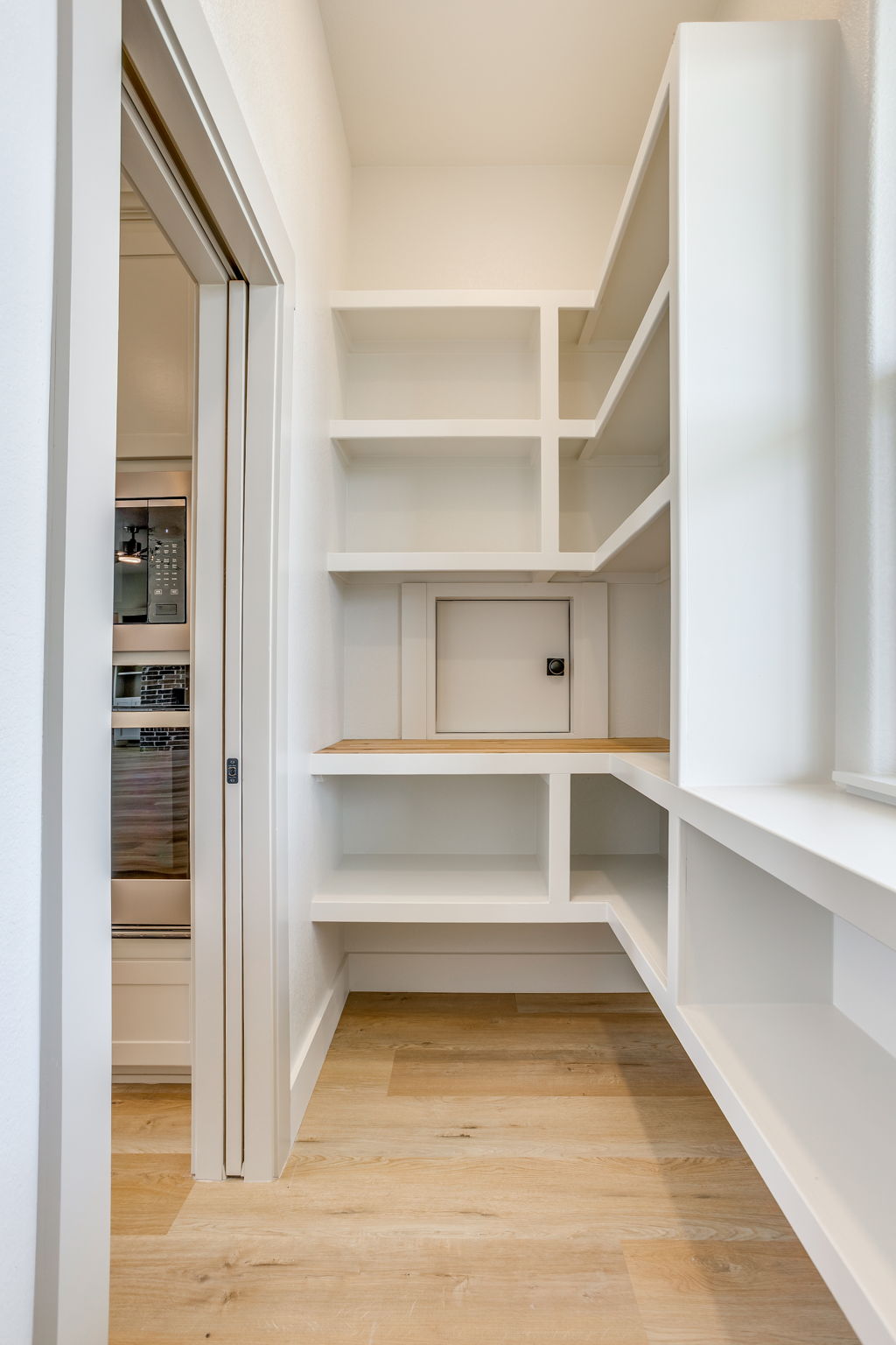 Pantry with extensive storage and a pocket door