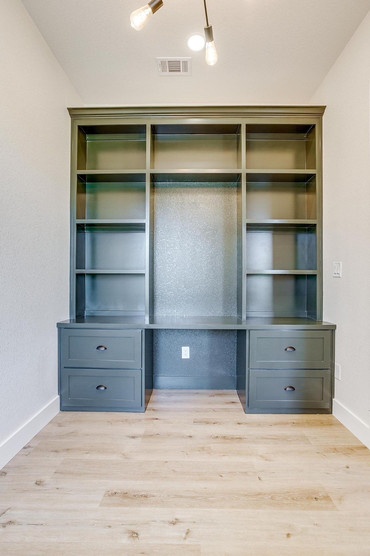 Straight-on view of the dark green built-in office cabinetry