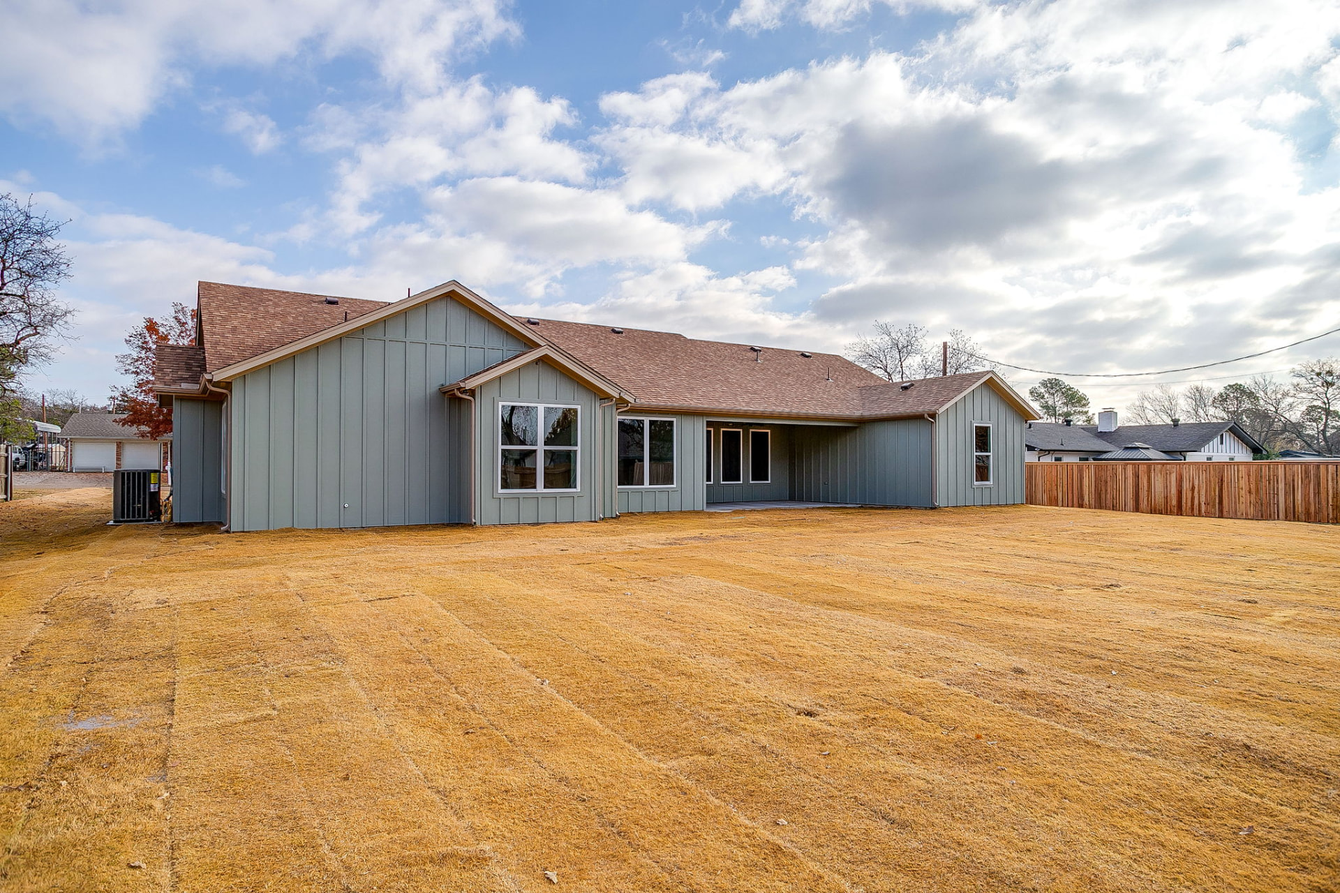 Side and rear exterior showing the gabled rooflines of the custom build