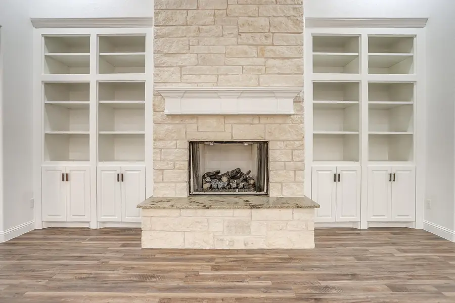 Wide view of the great room and stone fireplace wall