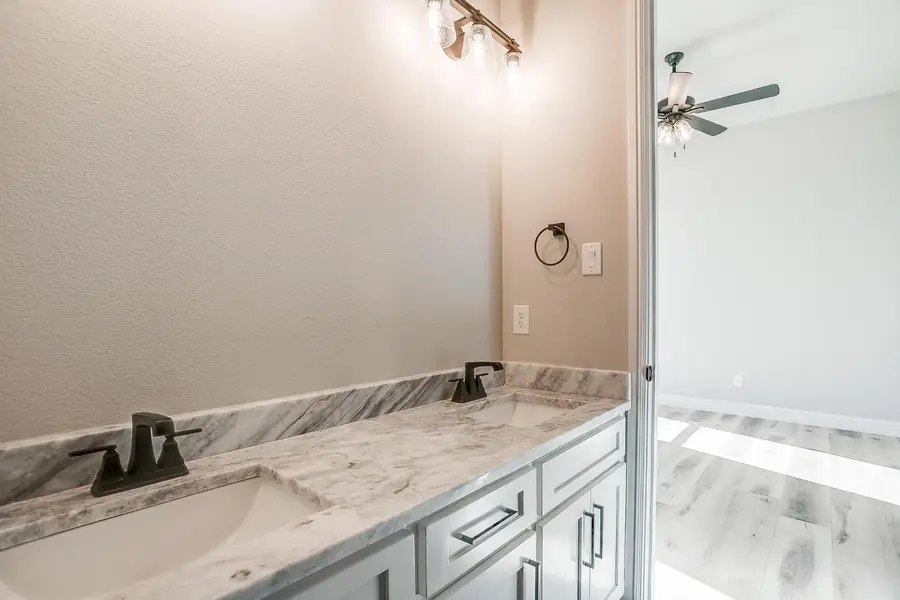 Guest bath double vanity with marble top and black fixtures