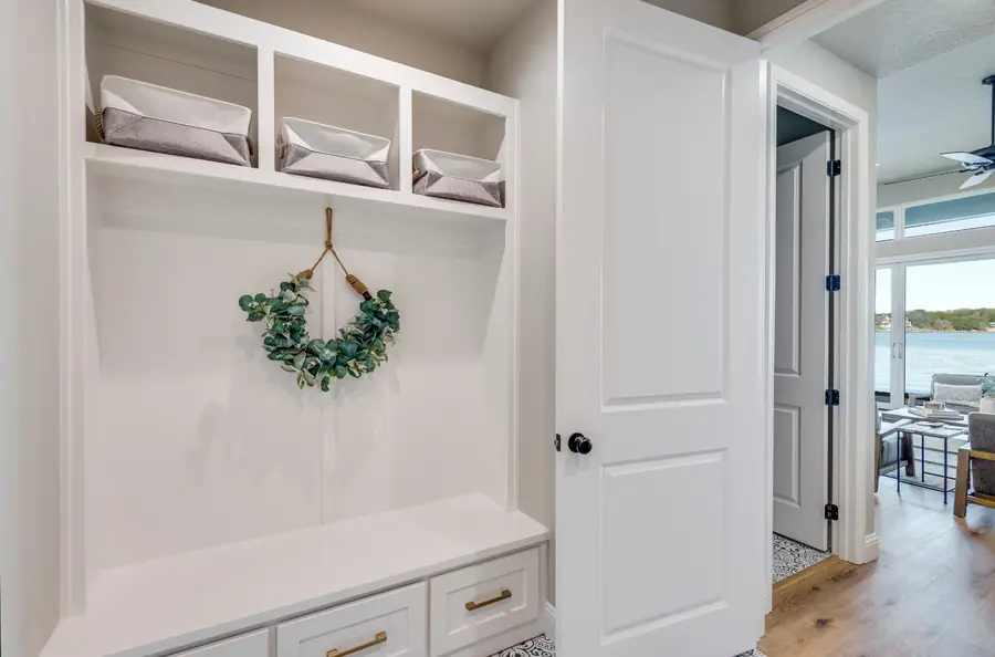 Mudroom with white built-in cubbies and bench