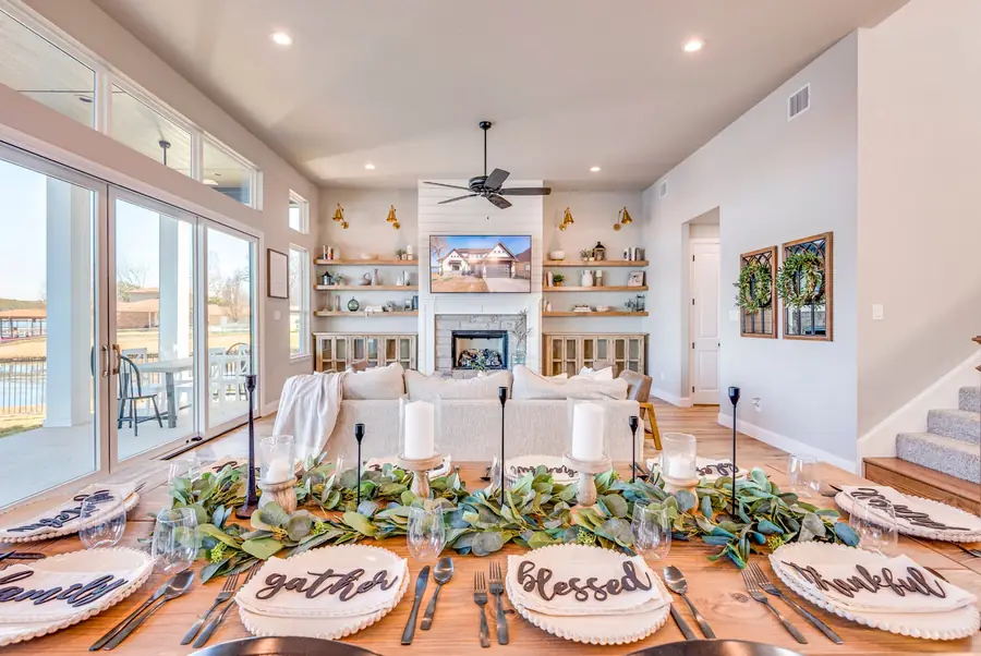 Vaulted living room filled with natural light from the dining side