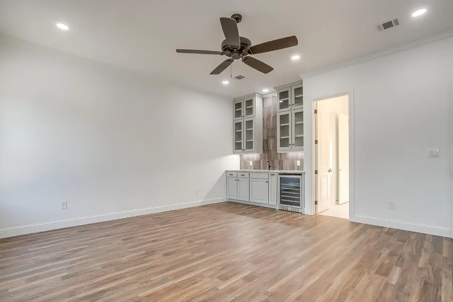 Game room with a built-in wet bar and wine refrigerator