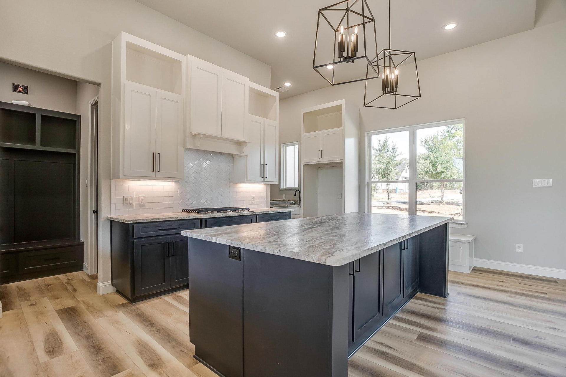 Kitchen island and perimeter white cabinetry