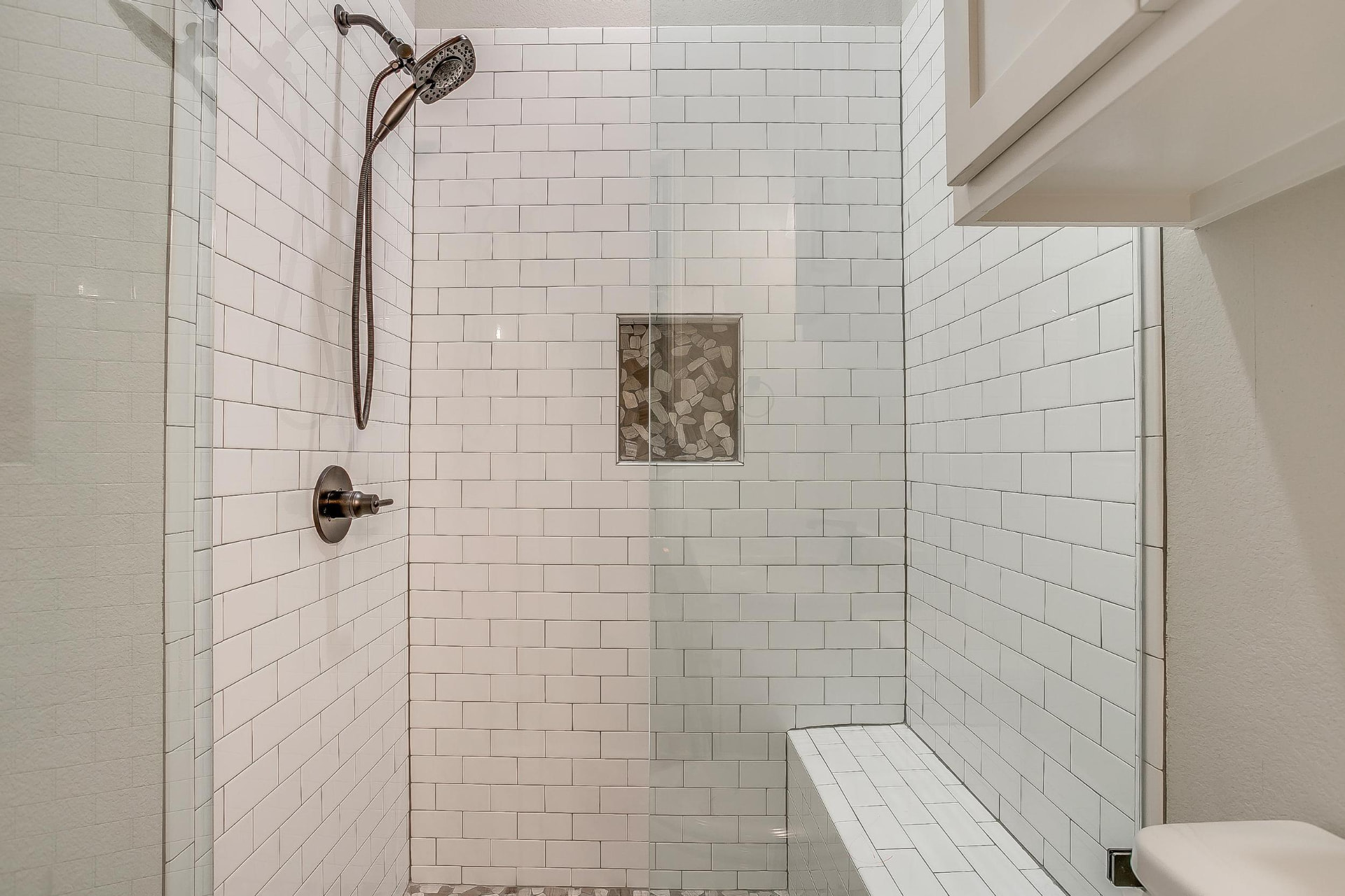 White subway tile shower with recessed niche
