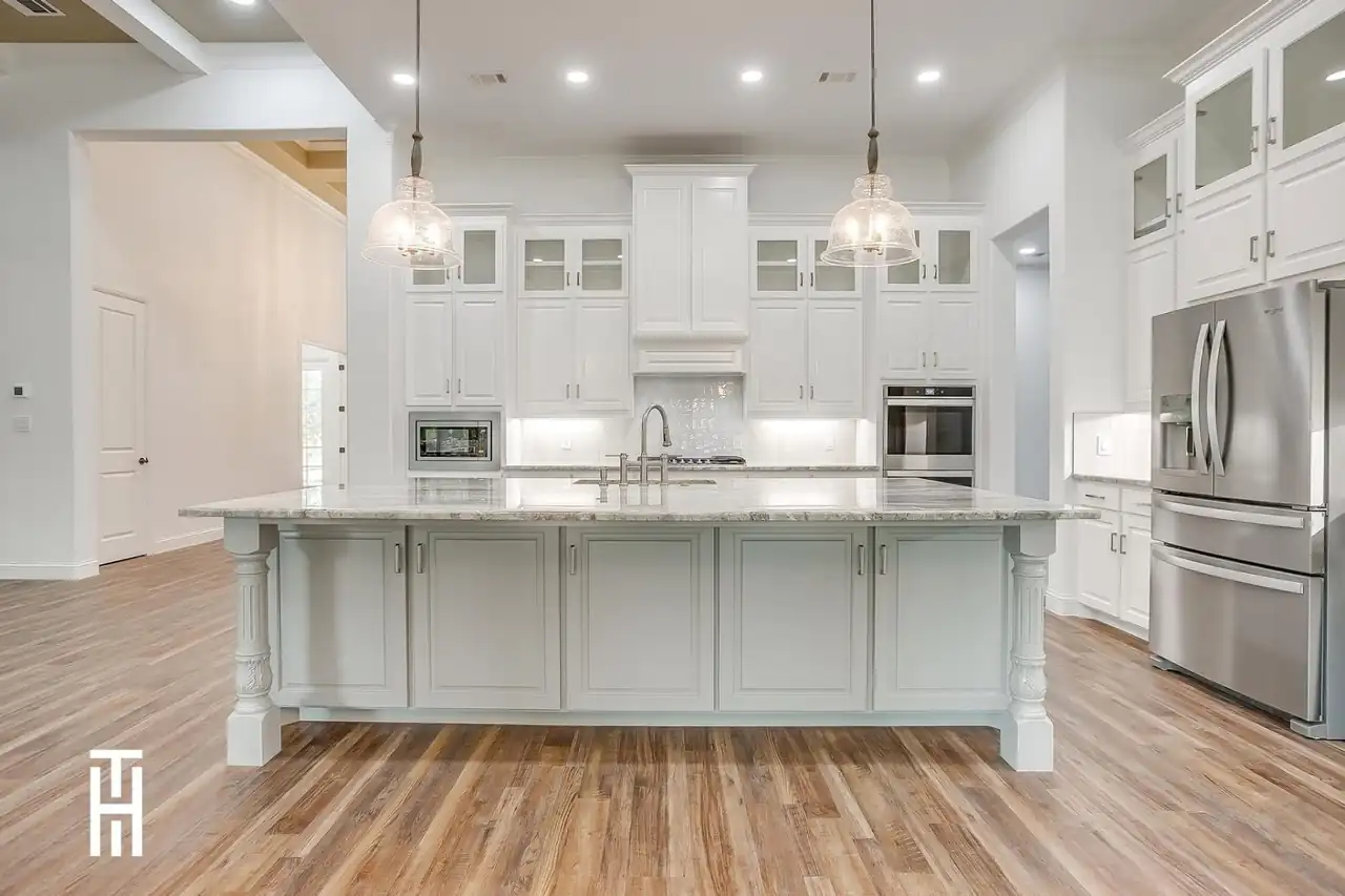 Contemporary custom kitchen with marble island built by Taylor Homes near Fort Worth